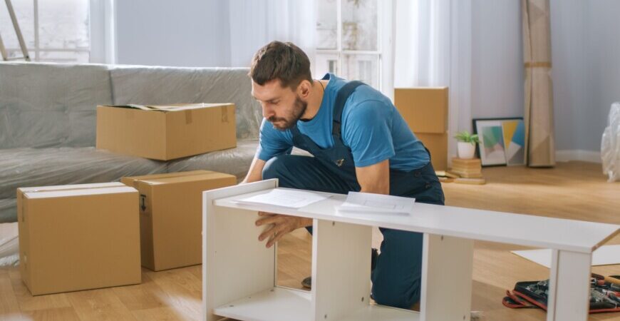Great Toronto Movers. Professional home furniture assembly services Toronto with the right tools. Man using professional tools to build tv stand.