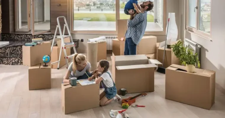 Residential moving solutions for smooth relocations. A happy family unpacking in their new home.