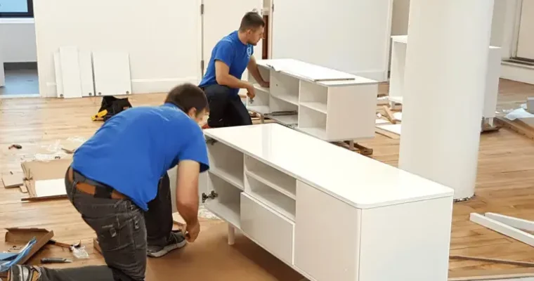 Furniture assembly solutions by Great Toronto Movers. Two movers carefully assembling a bookcase.