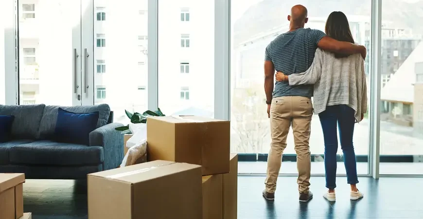 A young couple celebrating a stress-free move into their condo, thanks to the best apartment movers.