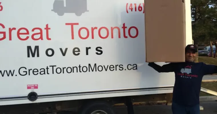 Labour-only moving solutions by Great Toronto Movers. A mover holding a wardrobe box during a relocation.