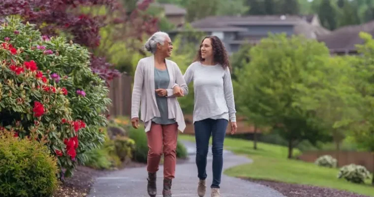 Senior moving solutions by Great Toronto Movers. A happy client walking with her mom after a seamless move.