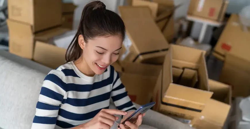 A young woman enjoys stress-free condo moving services with transparent, upfront pricing.