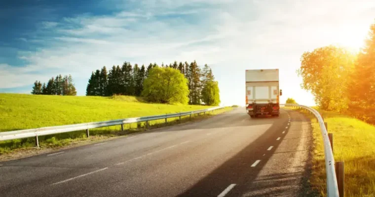 Long-distance moving solutions by Great Toronto Movers. A moving truck transporting items across a scenic highway.