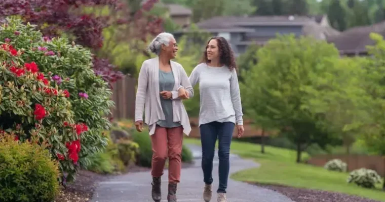 Trusted & flexible moving solutions for senior moves by Great Toronto Movers. A happy client walking with her mother after a caring and seamless move.